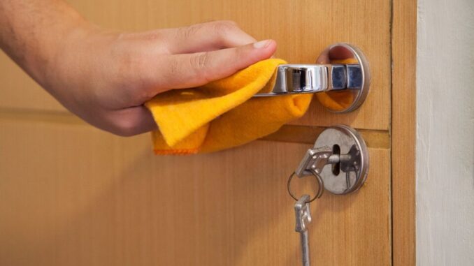 Cleaning,The,Door,Handle,For,Coronavirus,Prevention,During,Normal,New